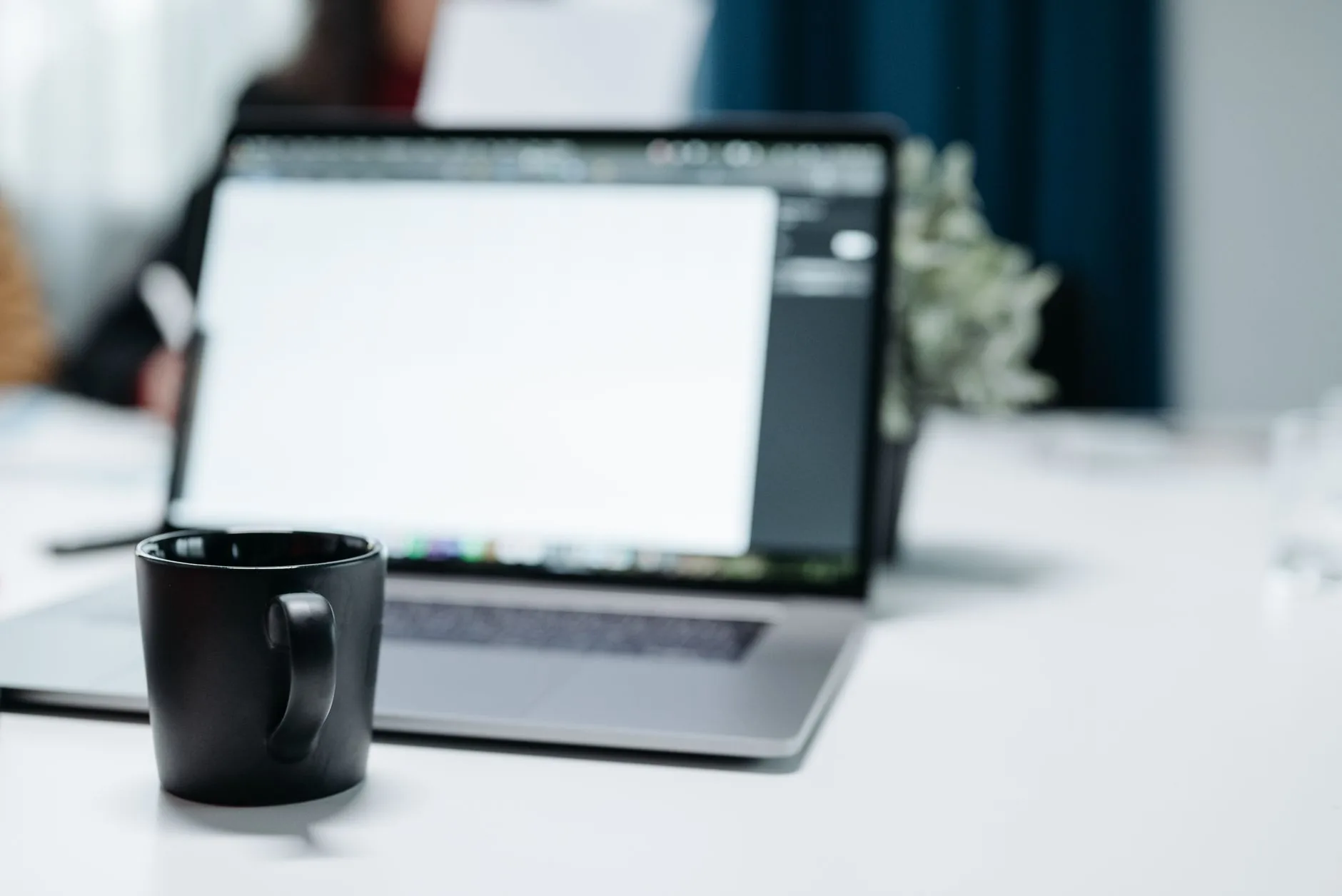 A young professional typing at a modern workstation, Gen Beta: The Next Generation Defined.
